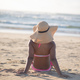Rear view of woman seen sitting alone at beach - PhotoDune Item for Sale