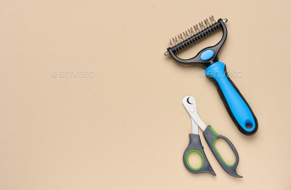Cat and dog grooming brush and nail clippers, top view
