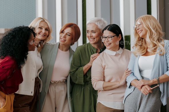 mture woman group Portrait of a group of mature women standing together and ...