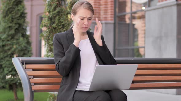 Sitting Outdoor Young Businesswoman with Headache Using Laptop alt
