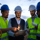 Group of engineers and maintenance workers looking at digital tablet together discussing plans. - PhotoDune Item for Sale