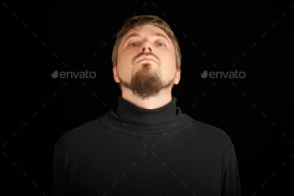 Cute bearded man, threw head back, black background