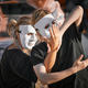Two women in white theatre mask dancing on art festival, outdoor art theatrical performance festival - PhotoDune Item for Sale