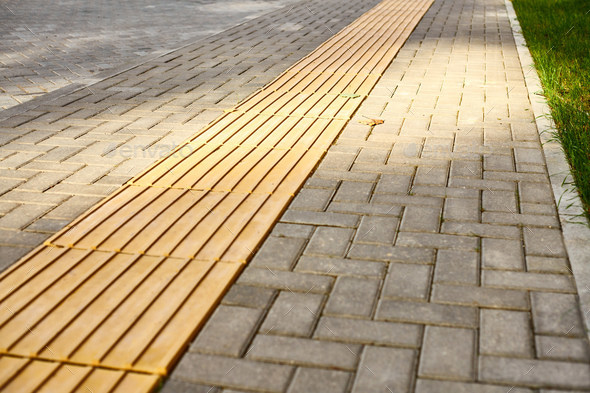 Yellow tactile paving on walkway, tactile ground surface indicators for blind and visually impaired
