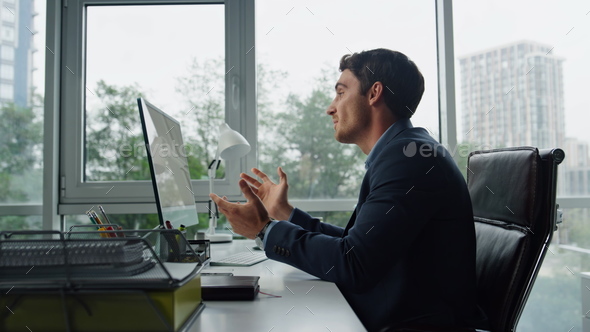 Handsome freelancer talking online at remote workplace. Office manager calling