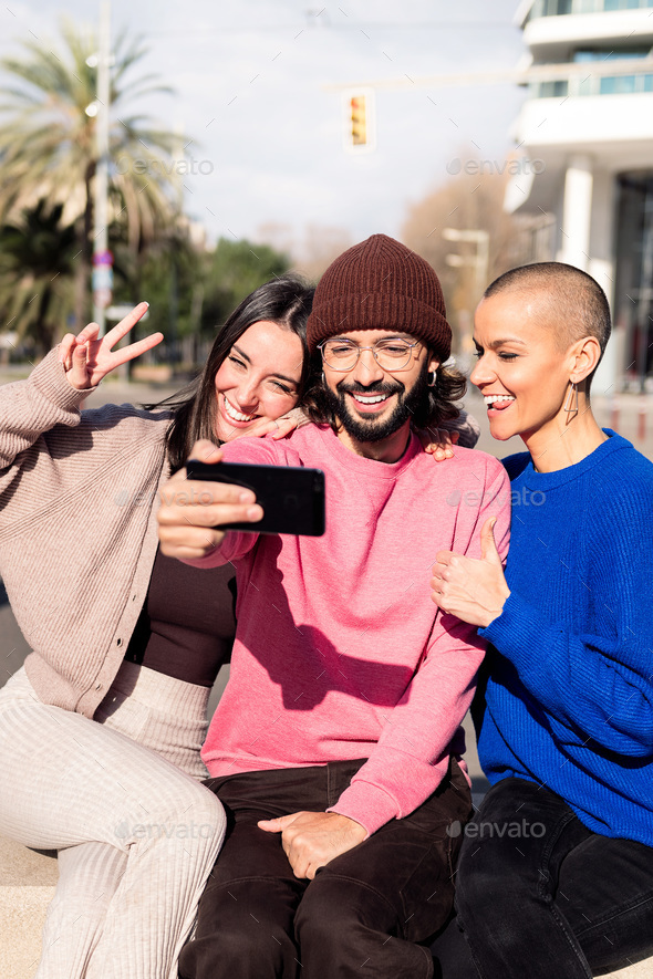 three funny friends taking a selfie in the city - Stock Photo - Images
