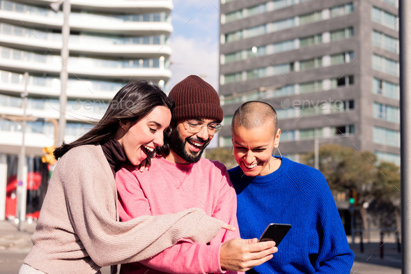 three young friends enjoying social media together - Stock Photo - Images
