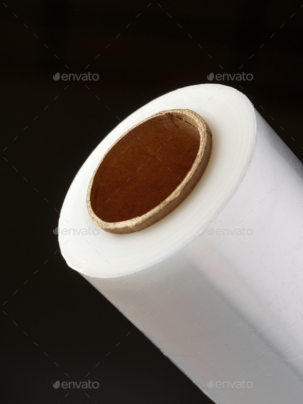 Roll of cling film isolated on black background
