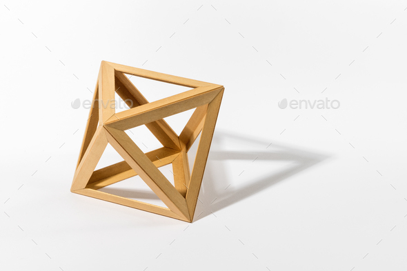Wooden octahedron on gray background