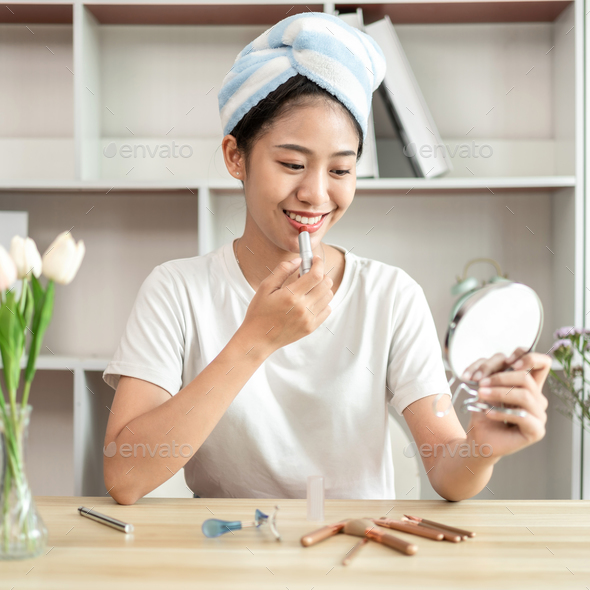 Half Japanese woman putting on makeup and hair to prepare for work in