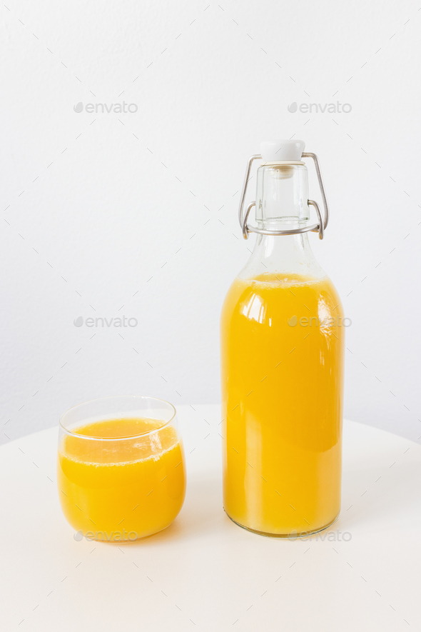 Glass jug with fresh orange juice on white background Stock Photo