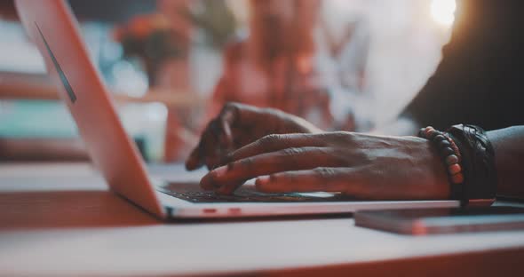 Man working on a laptop then picking up phone alt