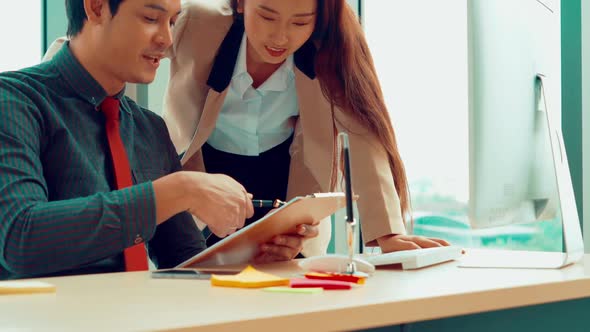 Two Business People Talk Project Strategy at Office alt