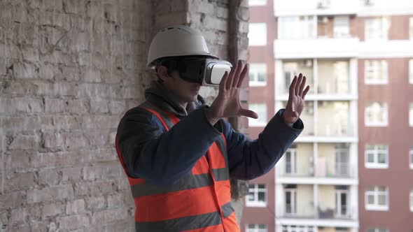 Builder designer designs a room in 3D virtual reality VR glasses. alt