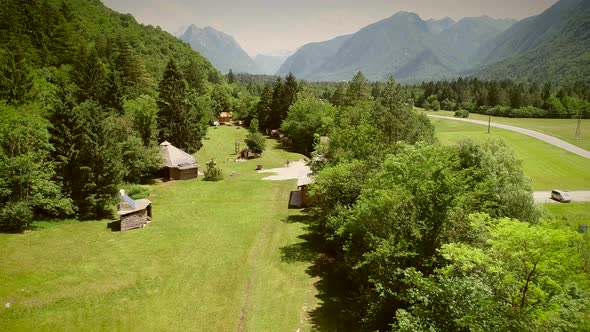 Aerial view of a summer camp with cabins and recreational area in the forest. alt
