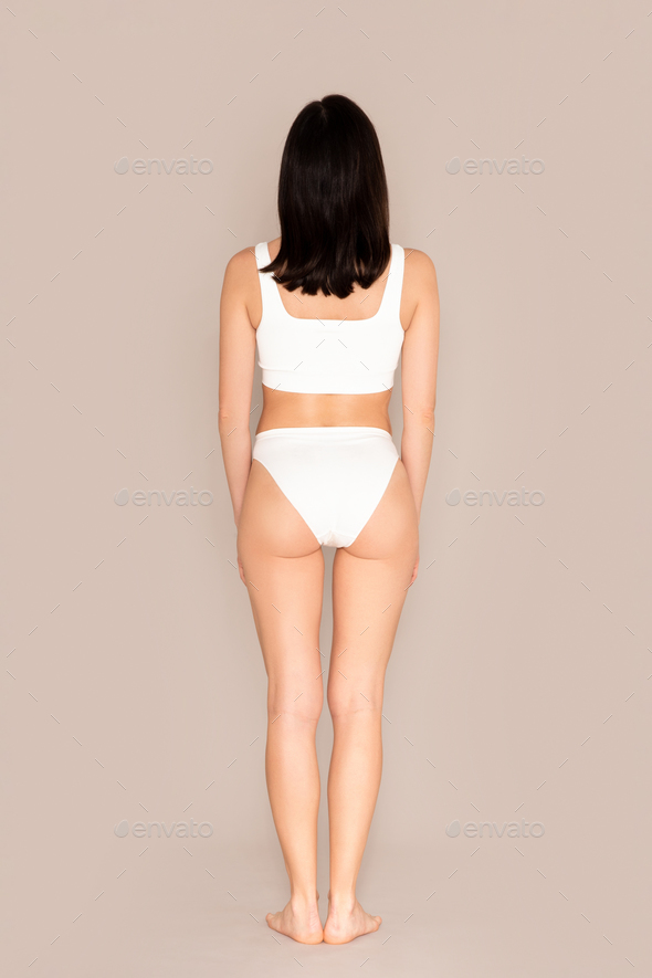 A slim brunette woman wearing underwear … – License image