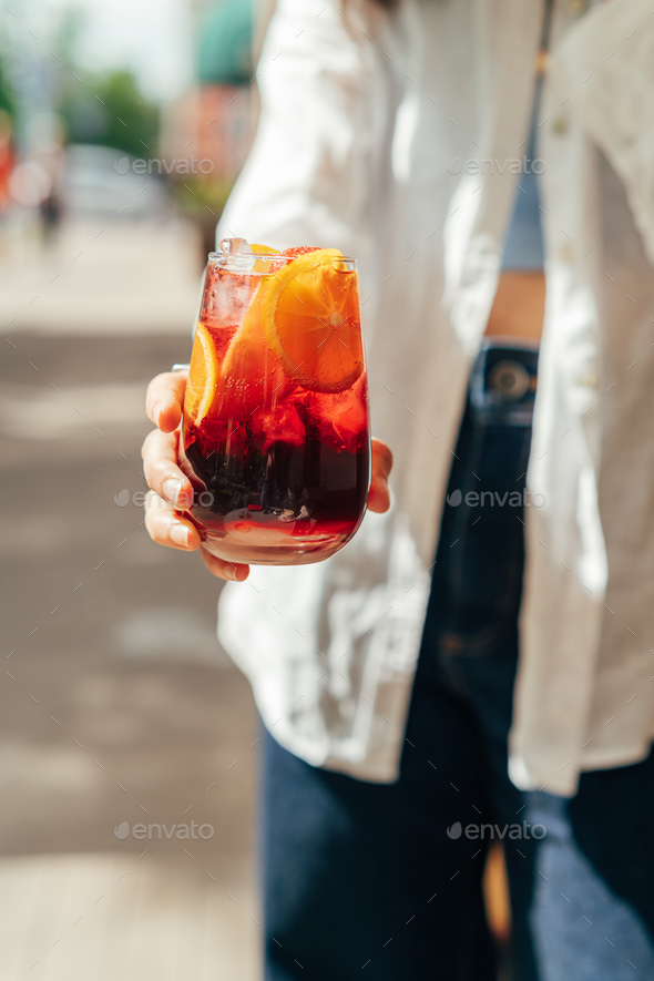Female holding sangria cocktail - Stock Photo - Images