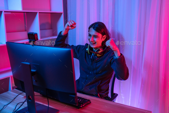 Handsome boy playing E-Sport game or streamer, Enjoying playing online games, Rejoices in victory