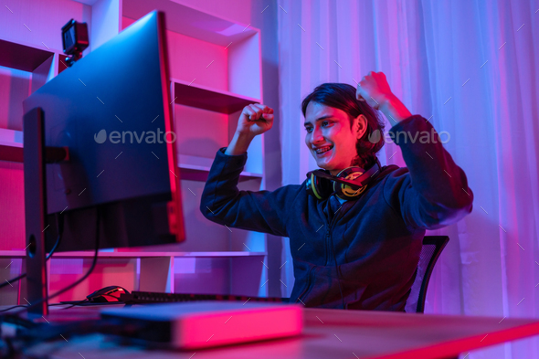 Handsome boy playing E-Sport game or streamer, Enjoying playing online games, Rejoices in victory