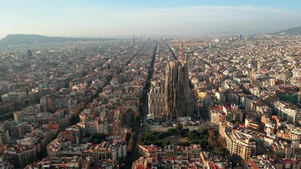 Aerial drone view of Barcelona, Spain. Blocks with multiple residential buildings and Sagrada Famili alt