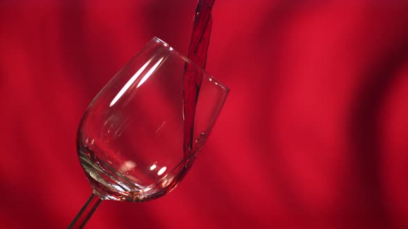 Red wine poured into a glass alt