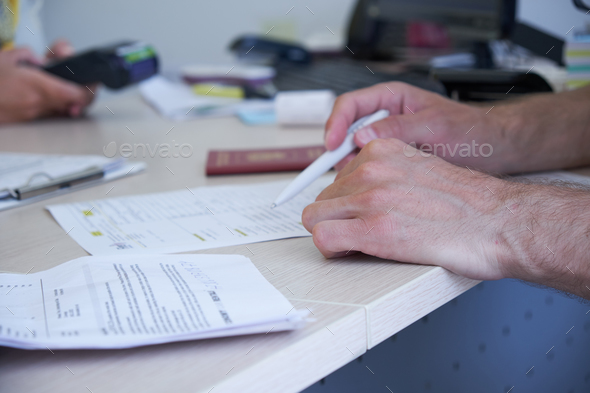 A man rents a car in the office, payment, car selection, signing the contract
