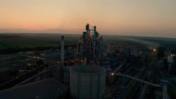 Cement Plant with High Factory Structure at Industrial Production Area at Sunset alt