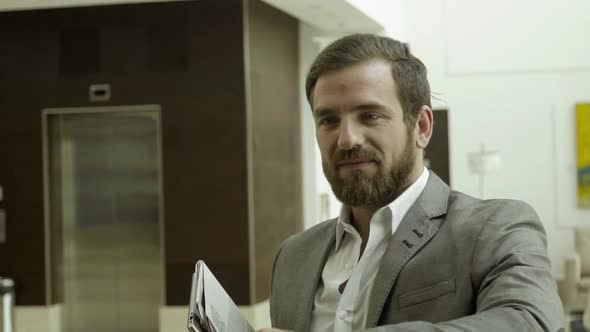 Businessman being handed hotel keycard alt