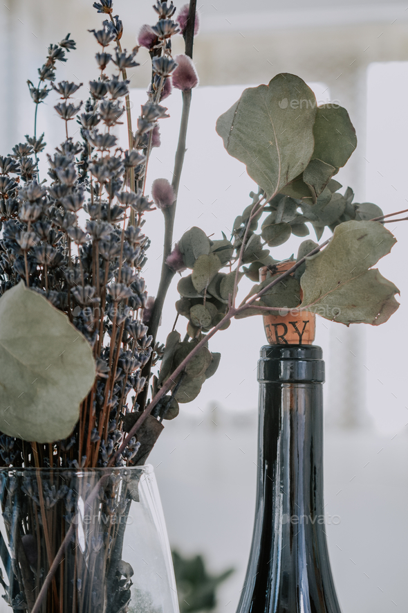 Vertical shot of a bottle of wine with ribbon and decorative straw