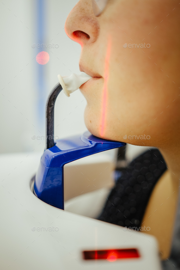 Vertical closeup shot of a dental patient using panoramic radiography equipment
