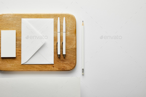 view from above of blank white paper on wooden table Stock Photo by  LightFieldStudios