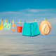 Beach hat, flip-flops and goggles hanging on a clothesline against sea and sky - PhotoDune Item for Sale