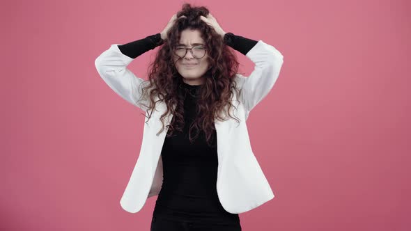 The Sad Young Woman Has a Headache Putting Her Hands on Her Head to Eliminate the Pain alt