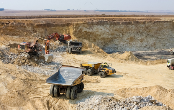 Dump trucks and excavators transporting manganese - manganese mining and processing
