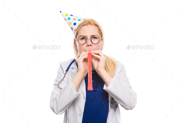 Woman doctor in white coat with party stuff