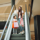 mother and little girl on the escalator in the mall.Mother and daughter in the mall. - PhotoDune Item for Sale