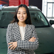 Long-haired brunette stands in front of a sparkling new car - PhotoDune Item for Sale