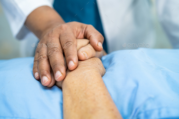 Holding hands Asian elderly woman patient with love, care, encourage and empathy at hospital. - Stock Photo - Images
