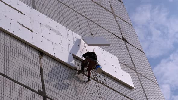 Industrial Climber Insulation of Facade Old High-Rise Building Using Styrofoam alt
