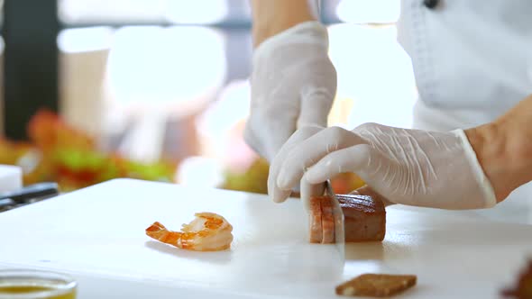 Knife Cuts Cooked Fish Meat. alt