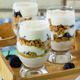 Vegan Dessert with whipped cream, nuts, oatmeal, prunes and sesame in glass glasses. - PhotoDune Item for Sale