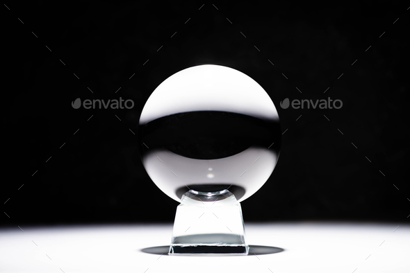 crystal ball on white surface on black background Stock Photo by ...