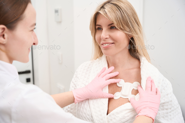 Doctor diagnostician attaches a special sensor for Holter examination