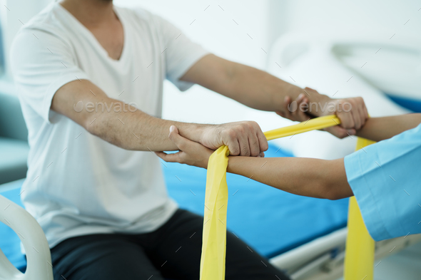 Close up hand patient doing stretching exercise with a flexible ...