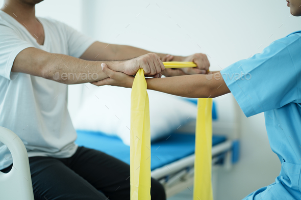 Close up hand patient doing stretching exercise with a flexible ...