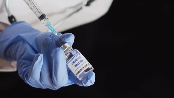 Doctor Takes COVID19 Vaccine Into Syringe