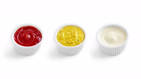 Stop Motion Animation with Ketchup Mustard and Mayonnaise in Bowls