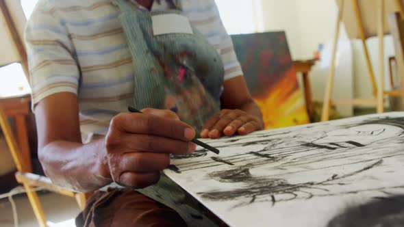 Artist drawing sketch at table alt