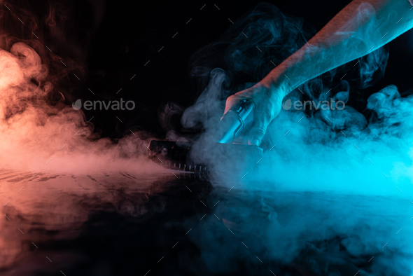 Disinfection with a steam cleaner. Steam on a black background