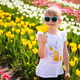 Child girl enjoying a smell of yellow tulip - PhotoDune Item for Sale